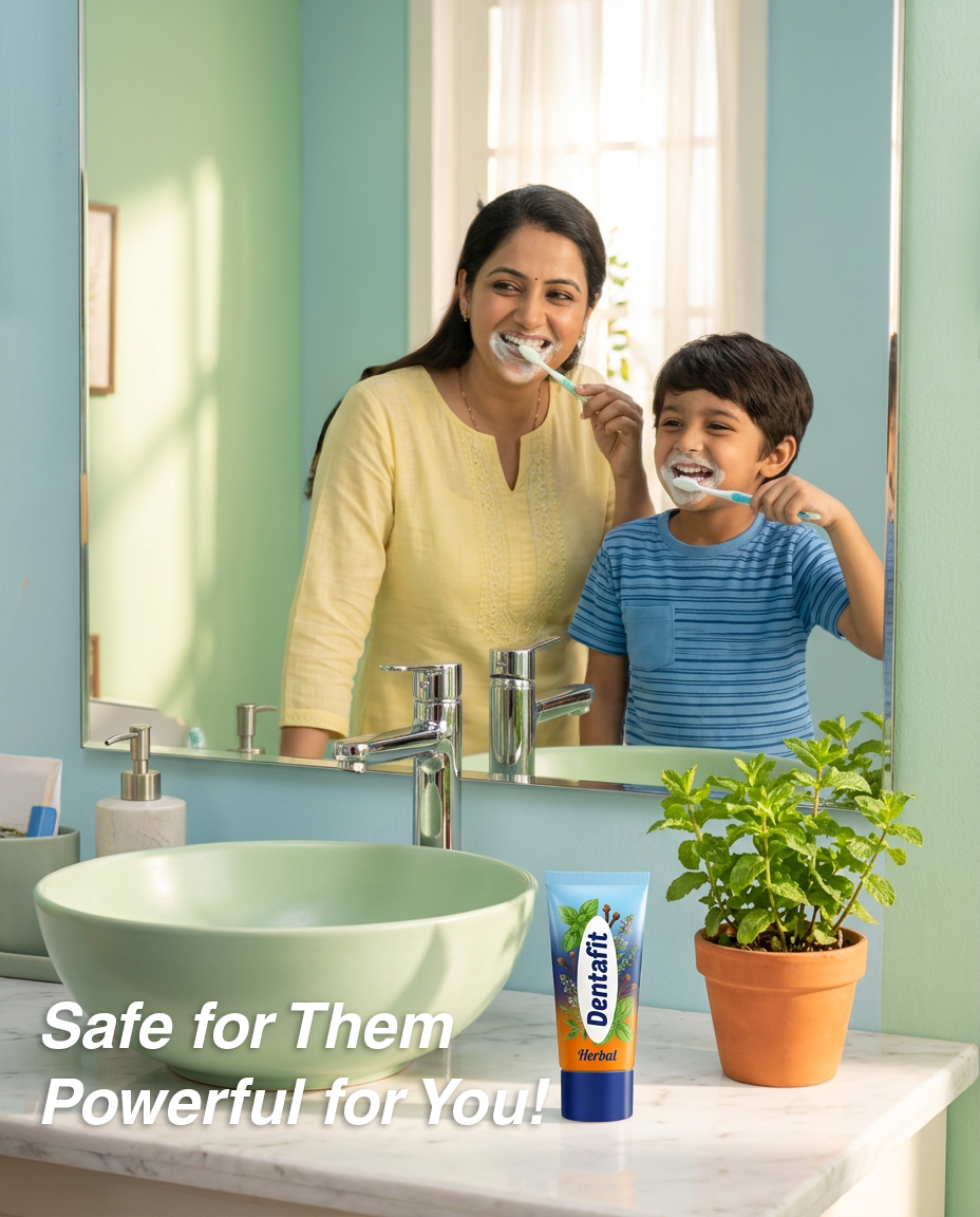 Mother and son brush their teeth together at the bathroom sink; a Dentafit Herbal toothpaste tube and a potted plant sit on the counter near a mirror with the overlay text 'Safe for Them Powerful for You!'