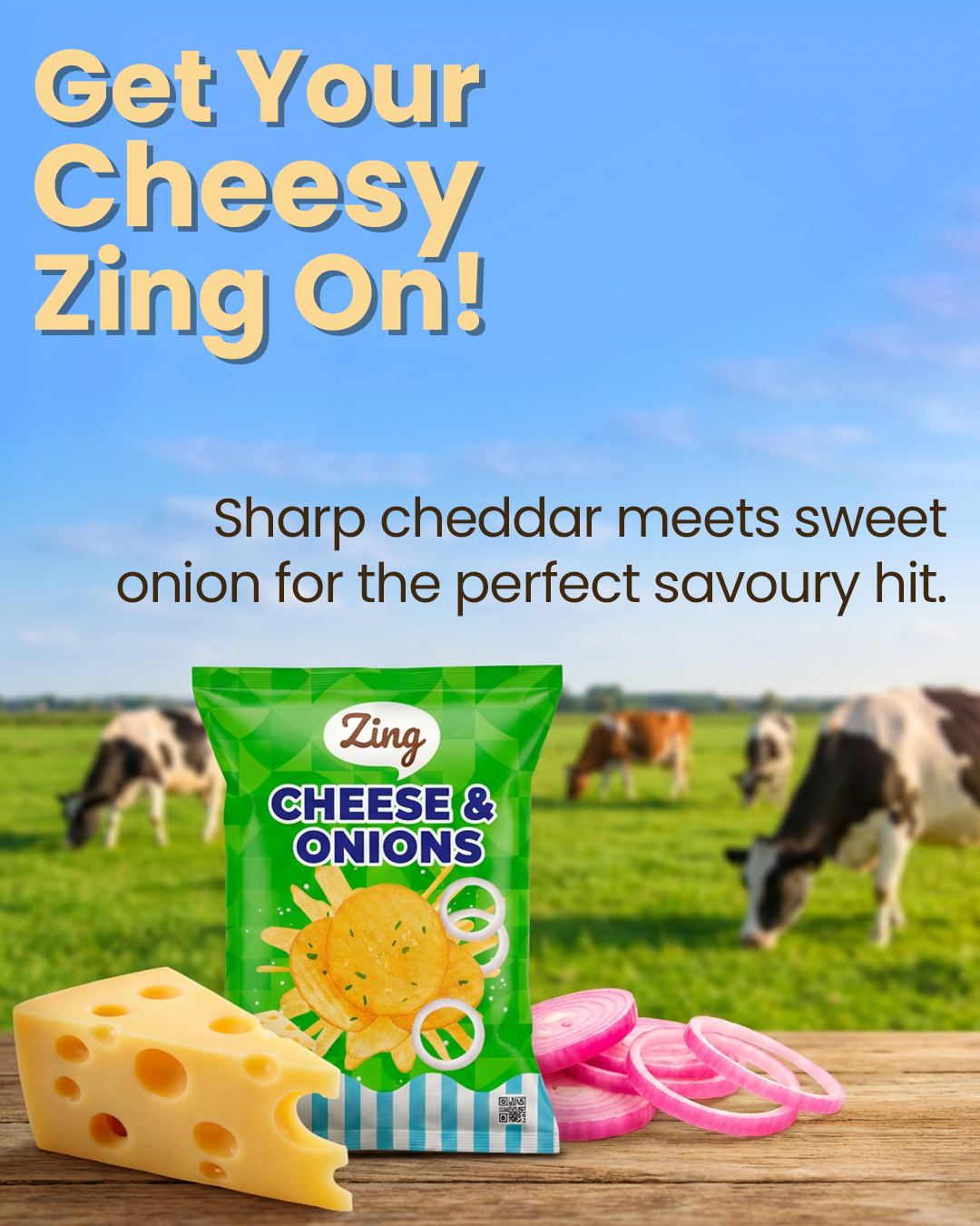 Bright ad with bold yellow text 'Get Your Cheesy Zing On!' over a blue sky; a green bag of Zing Cheese & Onions, cheese wedge, and onion rings on a wooden table, cows grazing in a field behind.